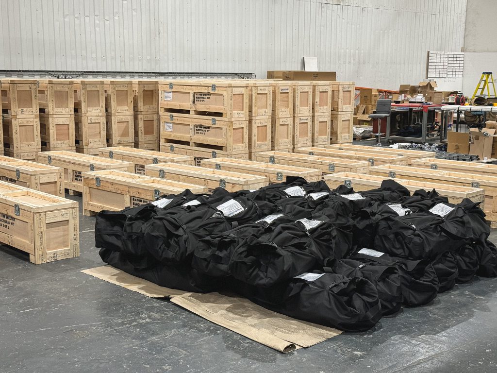 6m x 10m shelter lighting kits undergoing BS7671 testing and packaging in UK